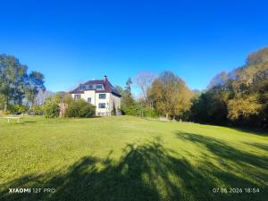 a large house in the middle of a grassy field at Chalets in nature Nedderhagen in Damshagen