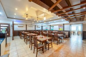 a dining room with tables and chairs in a restaurant at Vasco Residency in Vasco Da Gama