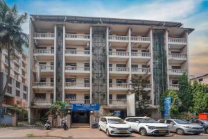 a large building with cars parked in front of it at Vasco Residency in Vasco Da Gama