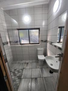 a bathroom with a toilet and a sink at Bushpigs Haven in St Lucia +11 photos