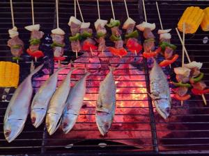 a bunch of fish are cooking on a grill at Europe Enchanted Bungalow Koh Rong in Kaôh Rŭng (3)