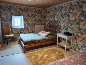 a small bedroom with a bed and a table at Domaine de la Bréssandière in Châtillon-sur-Thouet +56 photos