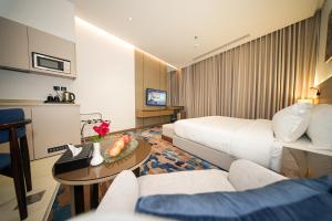a hotel room with a bed and a table at La Terrasse Hotel in Jeddah