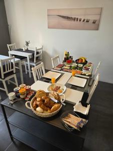 a table with food and bread and drinks on it at Jingtu Wellness & Spa Resort in Comares