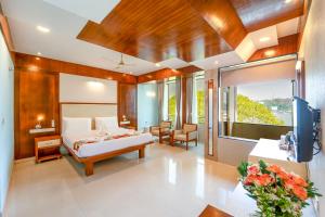 a bedroom with a bed and a living room at Panaji Residency in Panaji +37 photos