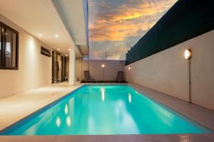 a swimming pool in a house with a sky at Villa Ptit Bouchon - En face de la Plage - Facing beach with Ocean views in Bouchon