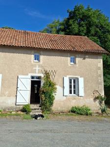 a dog laying in front of a building at Domaine de la Bréssandière in Châtillon-sur-Thouet