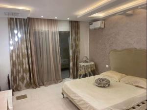 a bedroom with a large bed and a window at Beautiful villa with pool KELIBIA in Kelibia +20 photos