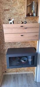 a drawer in a cabinet with a plate in it at Tiny House auf der Kingswood Ranch in Cornberg