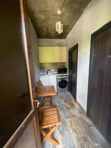 a small kitchen with a table and a sink at Muros Guesthouse in Mestia +8 photos