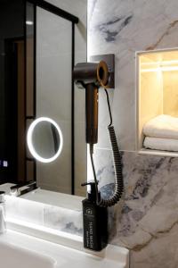 a hair dryer on a sink in a bathroom at Air Kostanay in Kostanay +13 photos