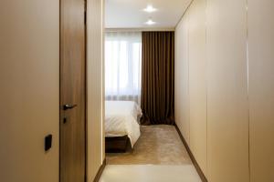 a small room with a bed and a window at Air Kostanay in Kostanay