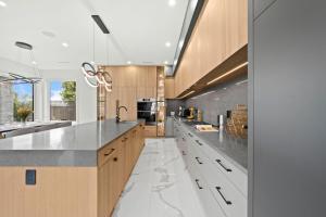 a kitchen with marble counter tops and wooden cabinets at North Shore Luxe Villa in North Vancouver