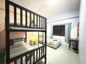 a bedroom with two bunk beds in a room at J Home in Ao Nang Beach