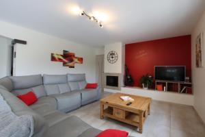 a living room with a couch and a table at Hergarai in Saint-Jean-le-Vieux