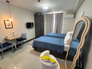 a hospital room with a bed and a desk and a table at JIYA Studio and Breakfast in Cebu City +27 photos