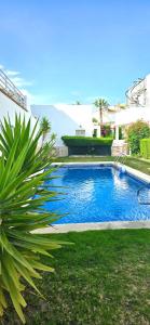 a swimming pool in a yard next to a house at Meerblick Pool Direkt am Strand in Cuevas del Almanzora