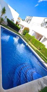 a large blue swimming pool in front of a building at Meerblick Pool Direkt am Strand in Cuevas del Almanzora +26 photos