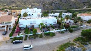 an aerial view of a large white house with palm trees at Meerblick Pool Direkt am Strand in Cuevas del Almanzora