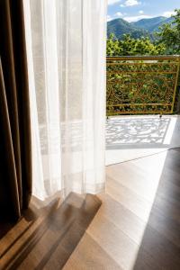 a window with a white curtain on a wooden floor at Hoàng Liên Hotel in Na Cốc +35 photos