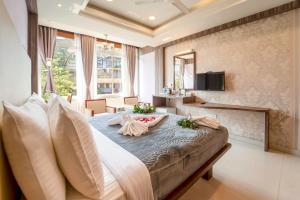 a bedroom with a large bed in a room at Panaji Residency in Panaji