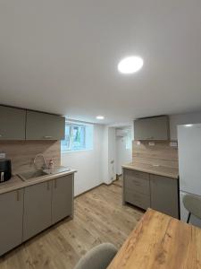 an empty kitchen with a table and a refrigerator at Boho style house Varna in Varna City