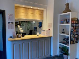 a store front with a counter in a room at L'Aiglon Bylitis in Porto-Vecchio