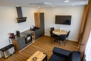 a living room with a table and a kitchen at M4 Apartment New in Freiburg im Breisgau