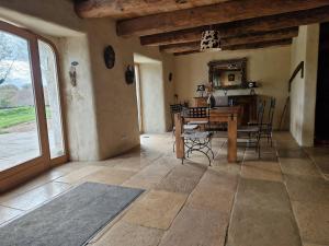 a living room with a wooden table and chairs at La Borie de Peyrot in Huparlac