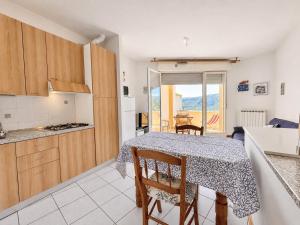 a kitchen and a dining room with a table and chairs at Hostdomus - Phil House in Finale Ligure +15 photos