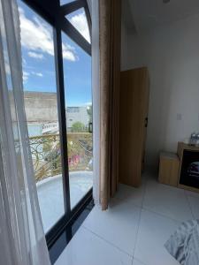 a room with a large window with a view at Lya Homestay CMT8 Da Nang in Danang