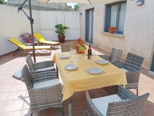 a yellow table and chairs on a patio at Apartamento La Camelia in Rosal +6 photos