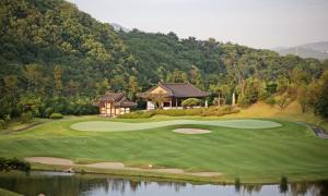 an aerial view of a golf course with a house at Seosansoo Golf & Resort in Seosan