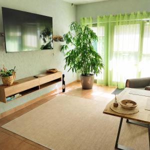 a living room with a table and a potted plant at Pension am Bernsteinmuseum Ferienwohnung in Ribnitz-Damgarten