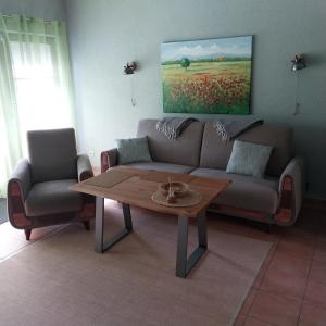 a living room with a couch and a coffee table at Pension am Bernsteinmuseum Ferienwohnung in Ribnitz-Damgarten