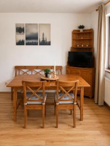 a dining room with a wooden table and chairs at Falkenstein Loft 55 in Zwiesel