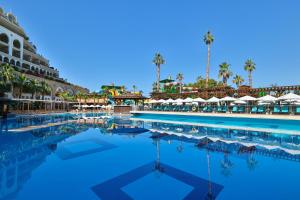 a swimming pool at a resort with palm trees at Crystal Sunset Pearl Collection - Ultimate All Inclusive in Side