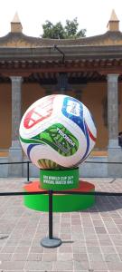 a large soccer ball on a display in front of a building at Estadio Azteca Banorte Suites in Mexico City