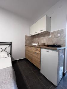 a kitchen with a white refrigerator and a sink at Salt & Sea in Sykia Chalkidikis