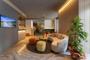 a living room with a couch and a table at Hotel Posta in Comano Terme