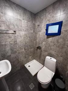 a bathroom with a toilet and a sink at Salt & Sea in Sykia Chalkidikis