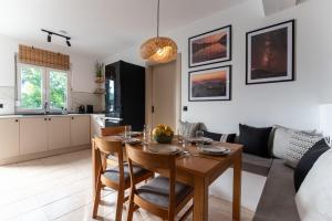 a kitchen and living room with a table and chairs at Gallery Home in Kardamaina