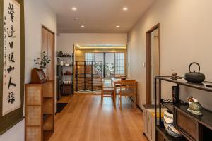 a living room with a table and chairs at 楓 和室の一棟貸切 最大10名宿泊可能 駅徒歩2分 関西空港直通 in Osaka