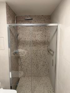 a shower with a glass door in a bathroom at Oravelle Loft Kubin in Dolný Kubín +25 photos