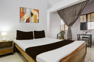 a bedroom with a large bed in a room with windows at Hotel Welcome Palace in Patna +13 photos