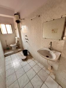 a bathroom with a sink and a toilet at Hotel Welcome Palace in Patna