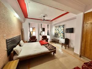a bedroom with a bed and a living room at Hotel Welcome Palace in Patna