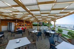 a restaurant with tables and chairs with a view at Crystal Sunset Pearl Collection - Ultimate All Inclusive in Side