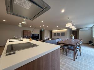 a kitchen and dining room with a dining table at Fubuki Kimobetsu in Abuta
