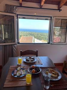 a table with two plates of breakfast food on it at Stavroula's House in Argyrádes